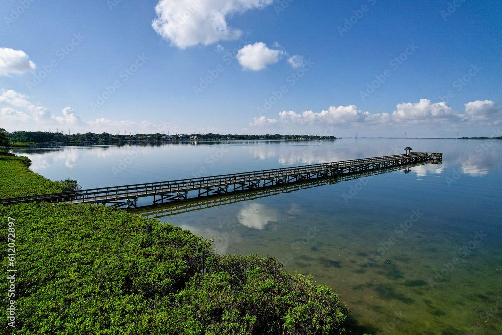 A drone photo of fishing pier in Tampa Bay, Florida. An aerial view of the natural beauty of a city park.
