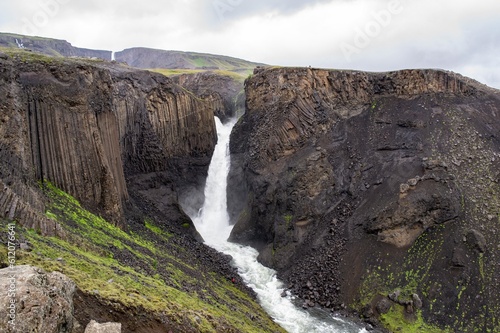 Litlanesfoss waterfall in Iceland with its basaltic geologic landscape in cloudy weather