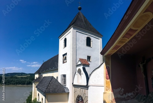 Ancient clock tower of Pfarre Schonbuhel church in Austria photo