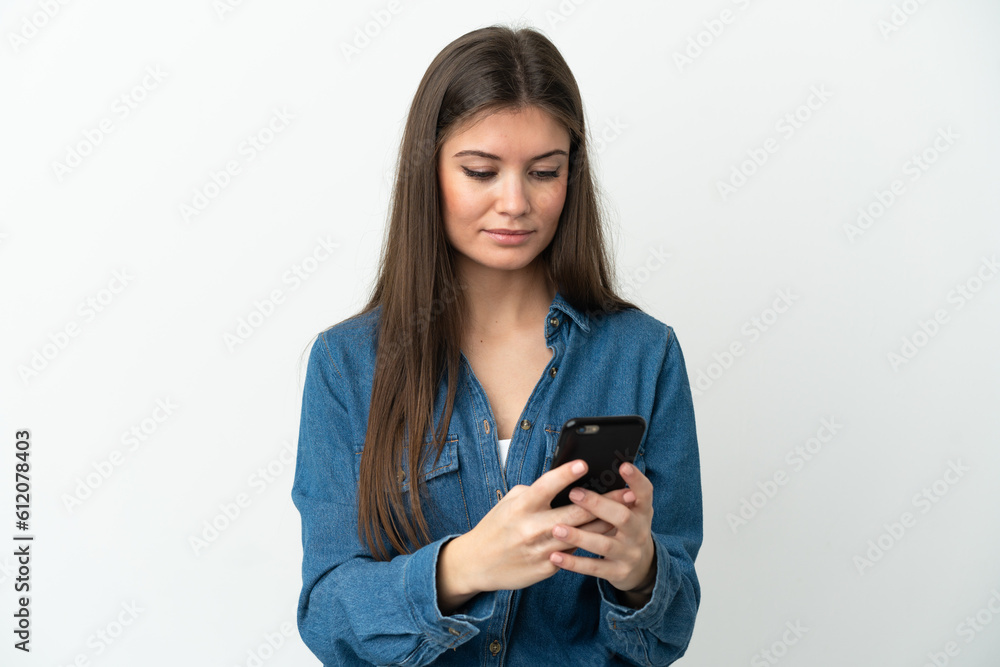 Young caucasian woman isolated on white background sending a message or email with the mobile Young caucasian woman isolated on white background sending a message or email with the mobile