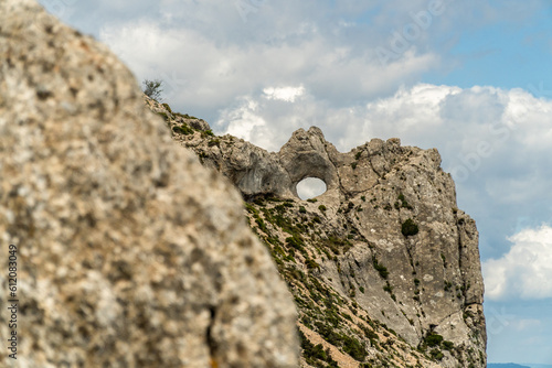 Peña Forata. Natural hole in the rock of the mountain, in Aitana (Alicante, Spain). photo