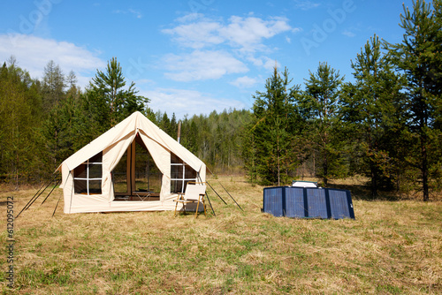Outdoor travel solar panel charging. Camping equipment, alternative power source © Sergey Kalsin
