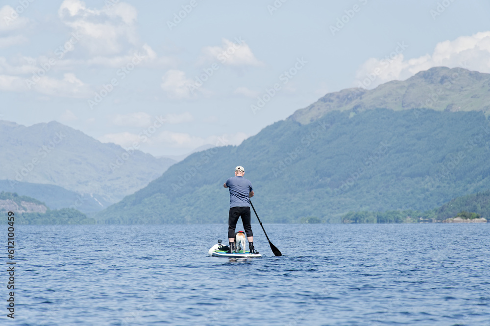 Naklejka premium Single man on a stand up paddle board during a summer morning