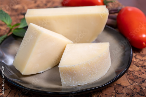 Italian cheese, Provolone dolce cow cheese from Cremona served with olive bread and tomatoes close up