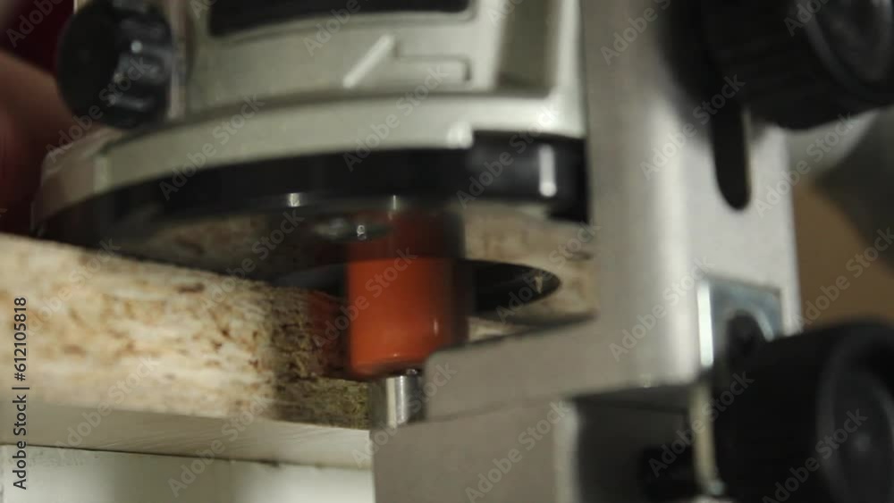 Joiner hands with milling router machine milling wood edge close up. Handmade. Joiner hands with milling router machine milling wood edge close up. Handmade.