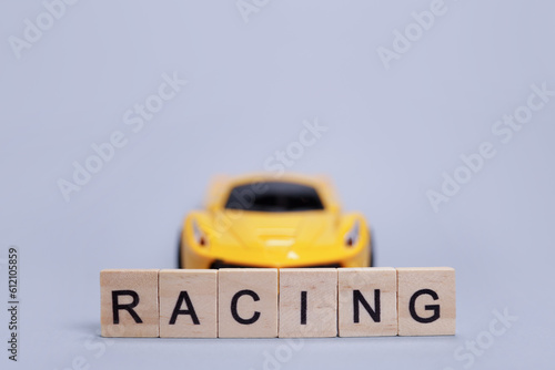 Toy car and word racing from wooden letters
