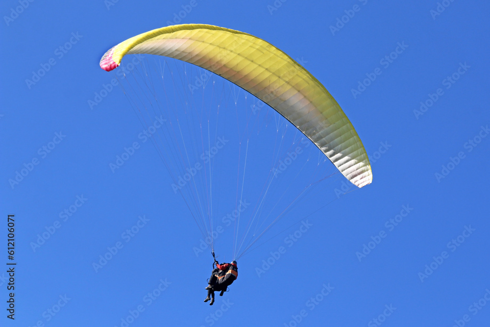 Tandem Paraglider flying in a blue sky
Tandem Paraglider flying in a blue sky