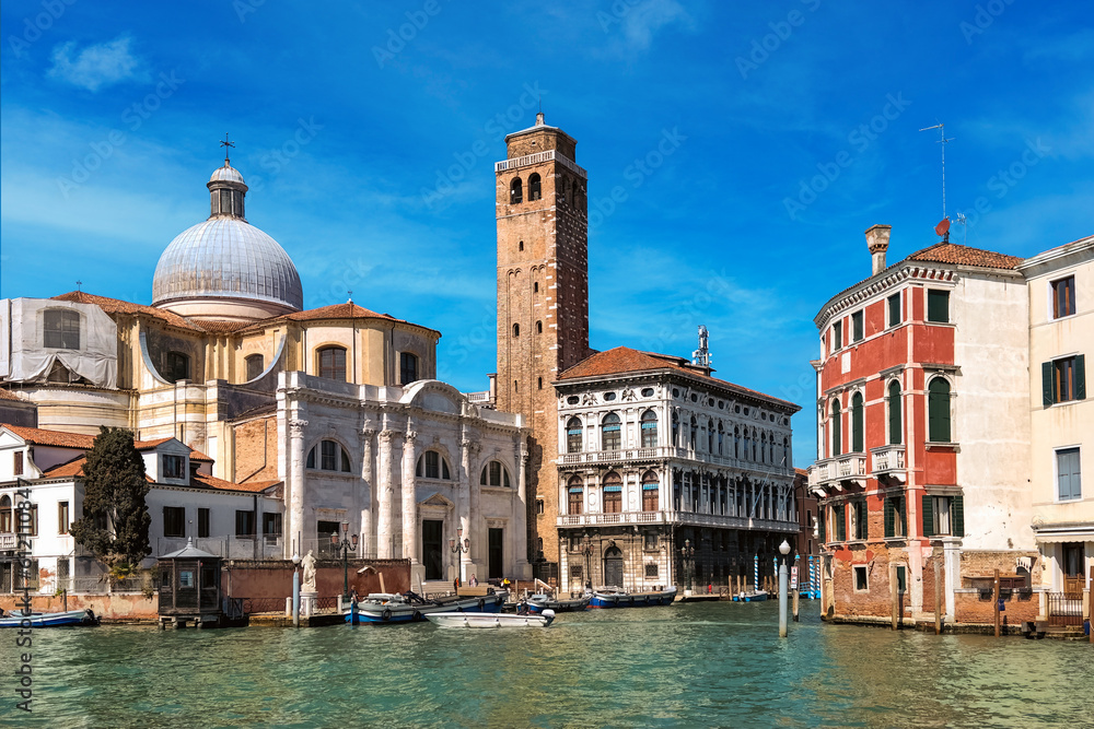 Old buildings, church and belfry on Grand Canal in Venice, Italy.