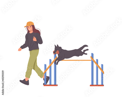 Young woman trainer teaching dog to jump over obstacles conducting agility training exercise