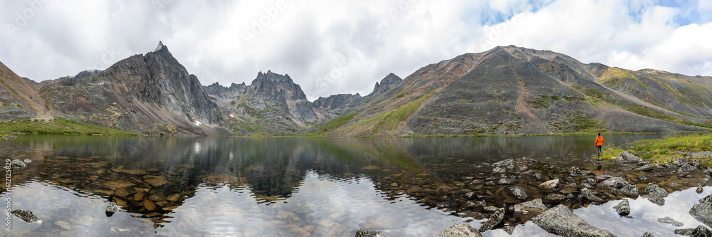 Panoramic mountain wilderness seen arctic Canada during summer time in Tombstone Territorial Park on Grizzly Lake hike expansive wild views panorama.