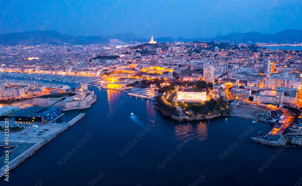 Panoramic night view of the old port and Notre Dame de la Garde Cathedral, city of Marseille in South France