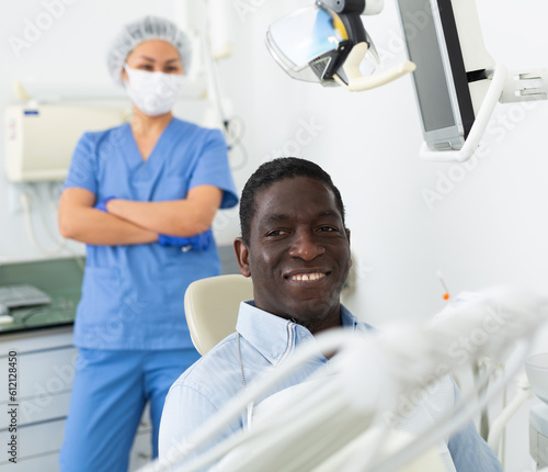 Portrait of satisfied male patient in a dental chair