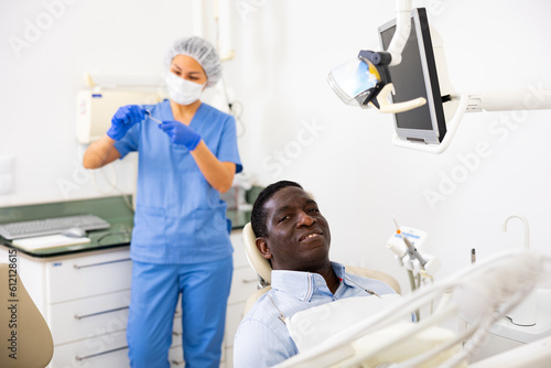 Portrait of satisfied male patient in a dental chair