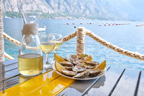 Oysters and white wine in a restaurant with a sea view
