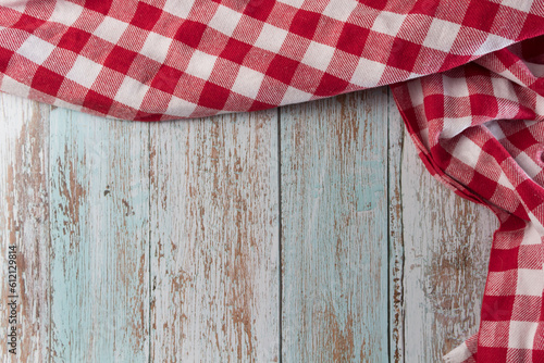 Red and white checkered tablecloth on a vintage wooden table