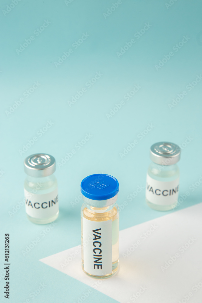 Above view of vaccine ampoules on pastel blue and white background with free space Above view of vaccine ampoules on pastel blue and white background with free space