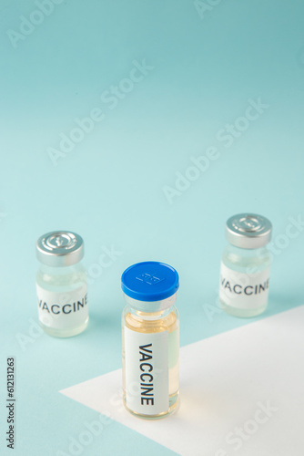 Above view of vaccine ampoules on pastel blue and white background with free space