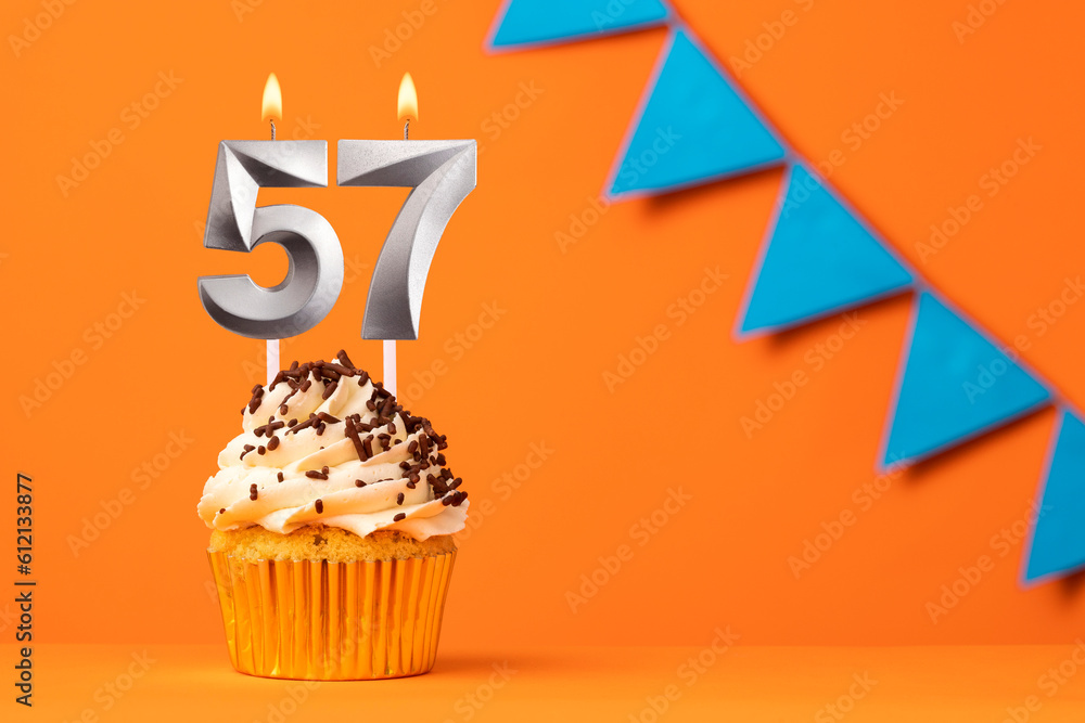 Birthday cake with candle number 57 - Orange background