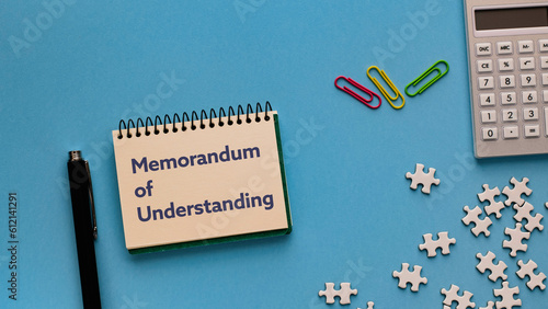 There is notebook with the word Memorandum of Understanding. It is as an eye-catching image. photo