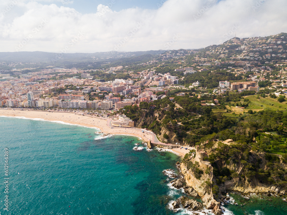 View from drone of Spanish town of Lloret de Mar on Mediterranean coast in summer day.