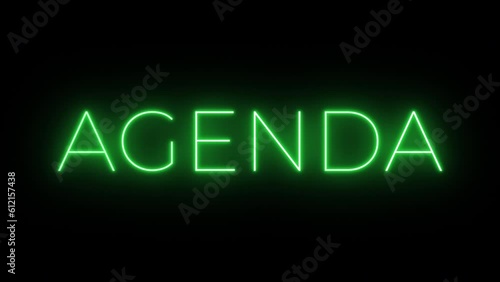 Flickering neon green glowing agenda text animated on black background photo