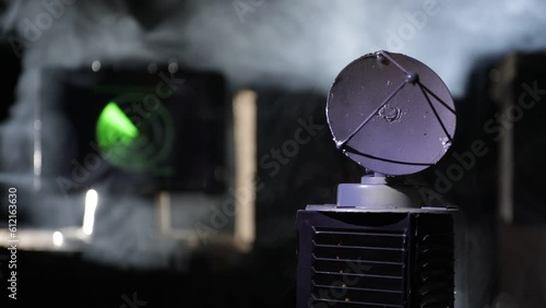 Creative artwork decoration. Military concept. Air defence hardware workplace vintage style. Satellite dishes or radio antennas against control equipment. Low key. Selective focus.