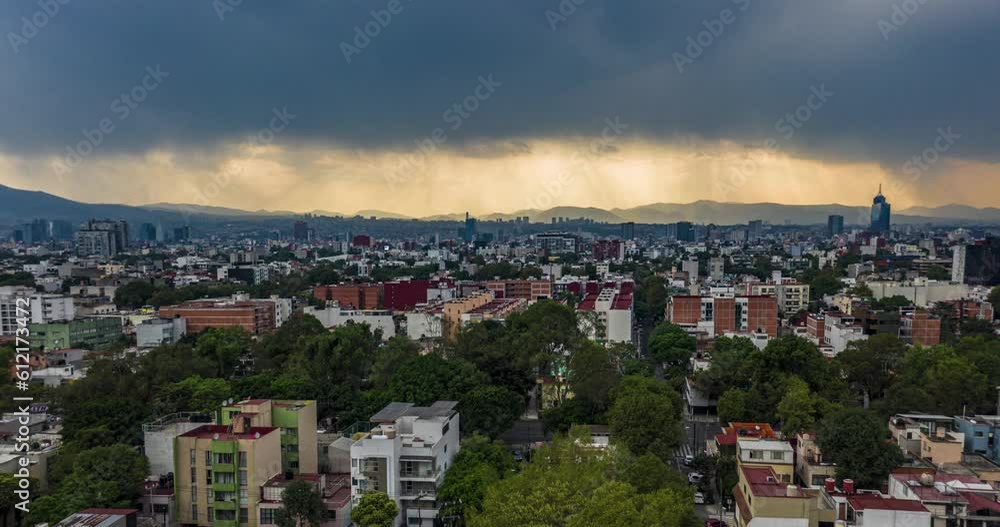 Aerial hyper-lapse panning shot from left to right of an urban landscape showing the city and the stormy clouds in the back, avenues full of cars passing by. Aerial hyper-lapse panning shot from left to right of an urban landscape showing the city and the stormy clouds in the back, avenues full of cars passing by.