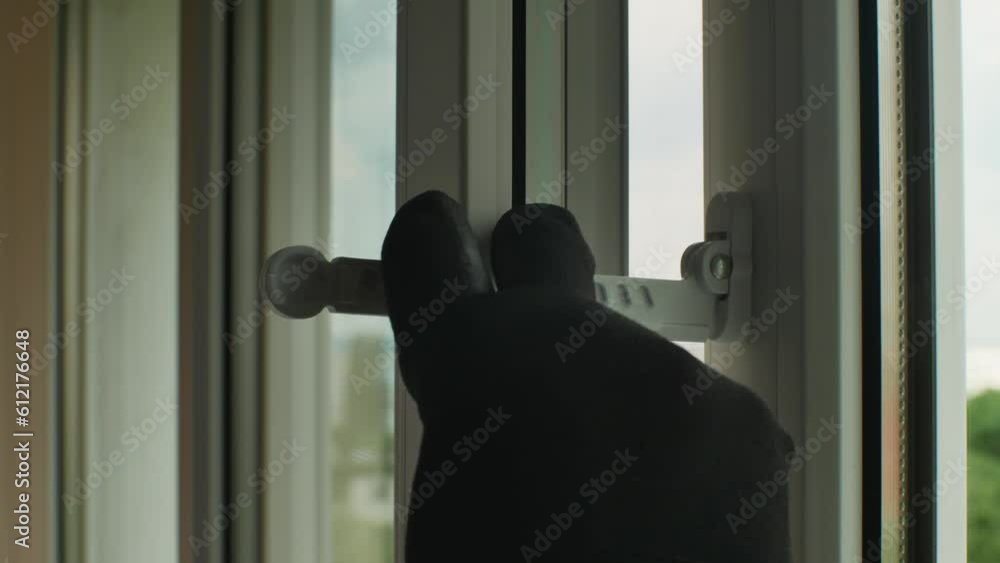 Window Hand Grip Close-up of a man's hand in a construction glove adjusting a window ...