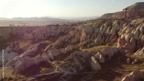 Drone view of Colorful red rose valley landscape in Cappadocia for sunset. Picturesque panoramic view of rock formations in the valley, Turkey