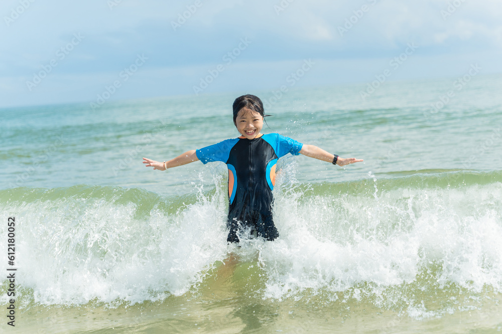 Happy child having fun on summer vacation. Child girl on the beach on sea shore.