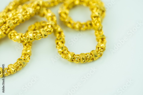 Detailed shot of luxury elegant gold necklace on a white background