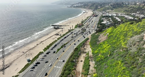 Pacific Palisades with cars on Pacific Coast Highway, aerial flyover photo