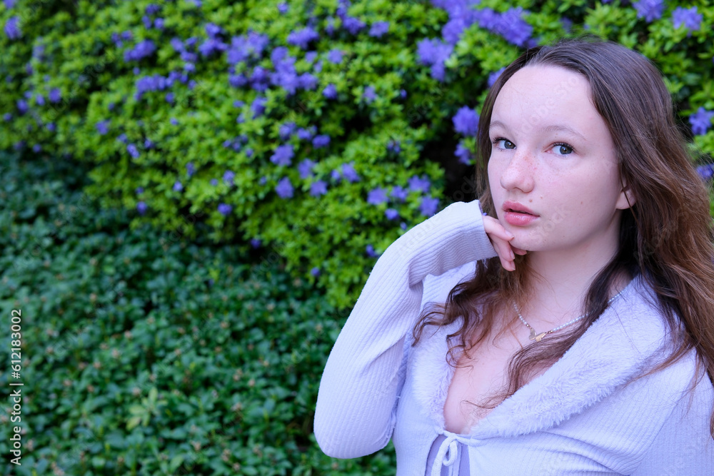 young woman on the street against the backdrop of blue flowers and greenery place for ad text beauty skin care natural remedies bruises under the eyes allergy tender lips loose hair teenage girl young woman on the street against the backdrop of blue flowers and greenery place for ad text beauty skin care natural remedies bruises under the eyes allergy tender lips loose hair teenage girl