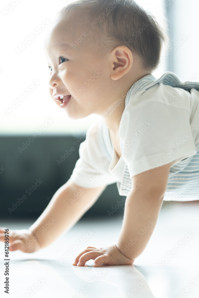 Chubby ginger baby boy in bodysuit, barefoot. He smiling, creeping on floor background with copy space, family fatherhood and parenthood concept, happy little baby girl with father at home Chubby ginger baby boy in bodysuit, barefoot. He smiling, creeping on floor background with copy space, family fatherhood and parenthood concept, happy little baby girl with father at home