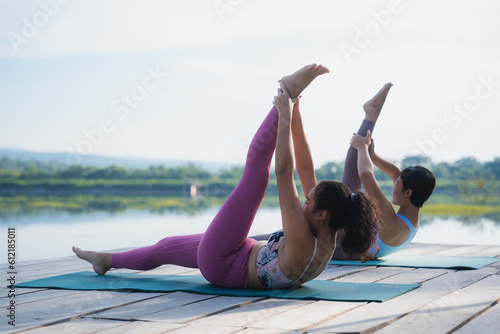 Yoga training for inner balance. Group of diverse women meditating at park, blank space, People doing yoga outdoor, Meditation and sport concept for healthy and relaxing lifestyle with nature field