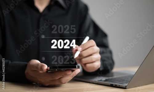 Businessman pointing year 2024. Business new year card concept.