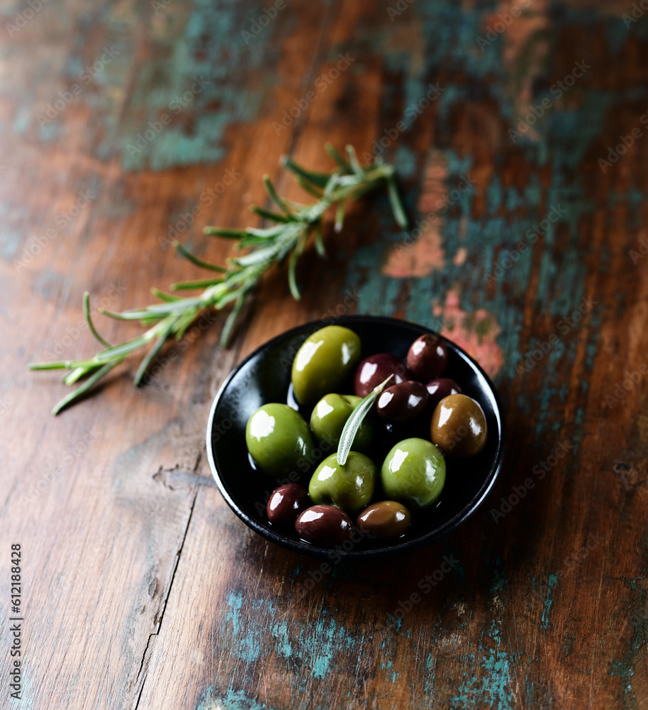 Various olives on rustic wooden background. Various olives on rustic wooden background.