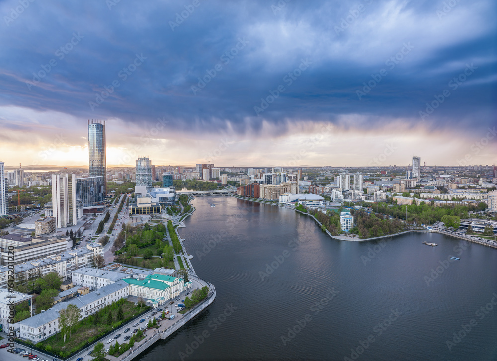 Fototapeta premium Yekaterinburg city and pond aerial panoramic view at summer sunset.