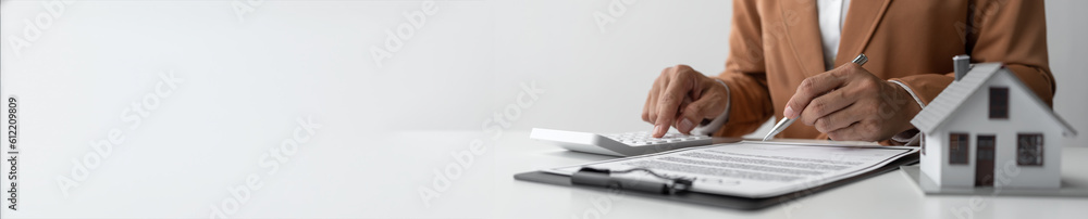Obraz premium House and insurance contract signing with agents, business women, calculations, terms and conditions of house and real estate contract documents Business contract concept copy space, panorama, banner
