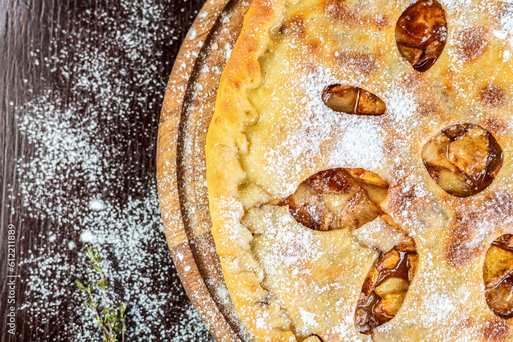A freshly-baked apple pie, a classic dessert dish for any occasion. Sweet and delicious with the aroma of fresh produce wafting indoors.