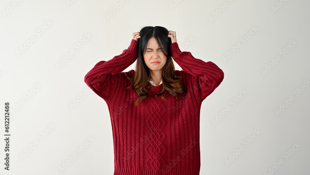 A pretty Asian woman feeling confused and headache-ridden during a hard decision A pretty Asian woman feeling confused and headache-ridden during a hard decision
