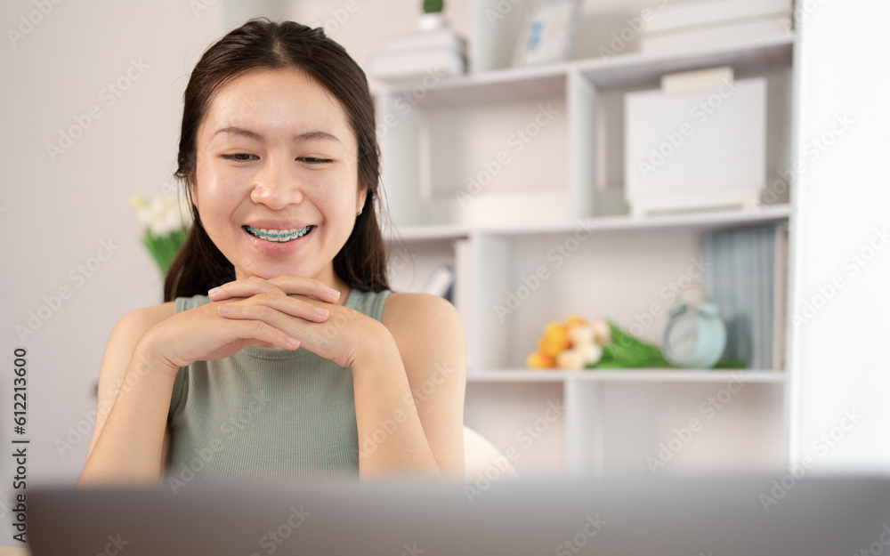 Young Asian female student watching teacher's live performance or video call on laptop in classroom at home, Conversations with teachers and classmates, Online learning, Study at your own home. Young Asian female student watching teacher's live performance or video call on laptop in classroom at home, Conversations with teachers and classmates, Online learning, Study at your own home.