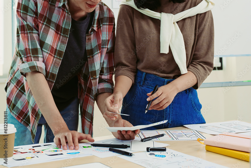 © Jirapong - Group of asian creative team programing designers participate in all phases of the UX UI design. © Jirapong - Group of asian creative team programing designers participate in all phases of the UX UI design.