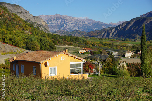 yellow old stone house in the mountains of the southern Alps, France with a valley view