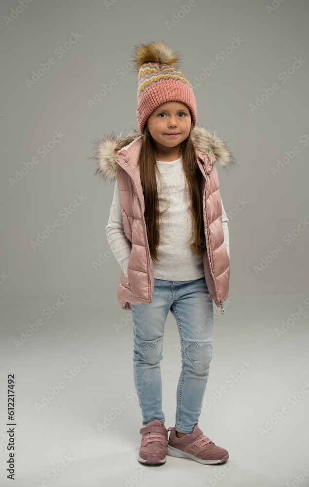 Full length of little girl, child, posing in warm jacket and hat isolated over white background. Copy space for ad Full length of little girl, child, posing in warm jacket and hat isolated over white background. Copy space for ad
