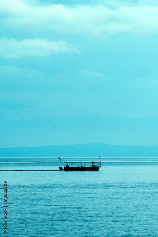 Silhouette of sailing boat at Kvarner bay of Adriatic sea in summer morning