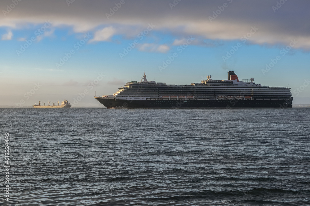 Luxury ocean liner cruiseship cruise ship Victoria or Elizabeth in port of Lisbon, Portugal during Mediterranean cruising with city skyline, Christos statue and suspension bridge