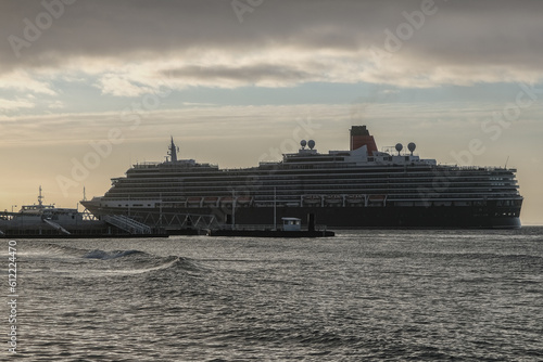 Luxury ocean liner cruiseship cruise ship Victoria or Elizabeth in port of Lisbon, Portugal during Mediterranean cruising with city skyline, Christos statue and suspension bridge