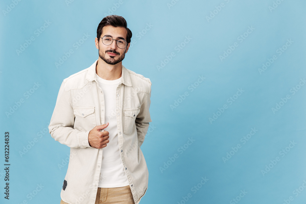 Portrait of a stylish man smile with teeth in glasses for farsightedness and myopia, on a blue background in a white T-shirt, fashionable clothing style, space space Portrait of a stylish man smile with teeth in glasses for farsightedness and myopia, on a blue background in a white T-shirt, fashionable clothing style, space space