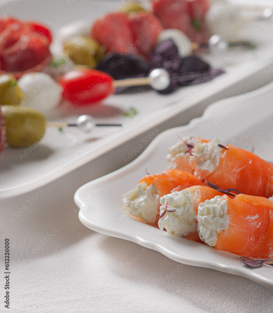 Festive table with white tablecloth and appetizers Festive table with white tablecloth and appetizers